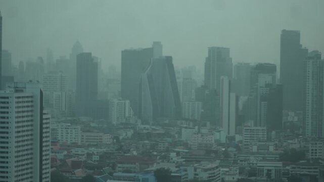 Cityscape of Bangkok covered by mixture of dust in air pollution. Heavy air pollution of fine particulate matter (PM2.5) in morning.