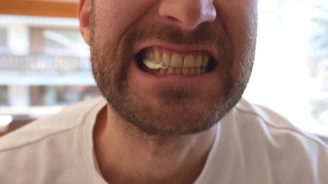 slowmotion Close up of man chewing gum with mouth open