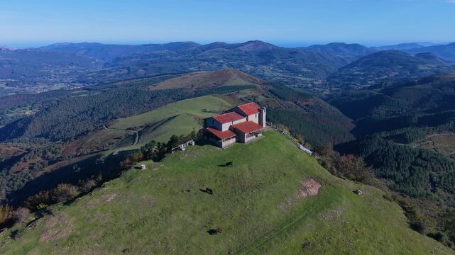 Aerial view from a drone of Mount Coliza (897 m) (Kolitza in Basque) with the chapel of San Sebasti&aacute;n and San Roque in the Ordunte Mountains in Valmaseda. Bizkaia, Basque Country, Spain.