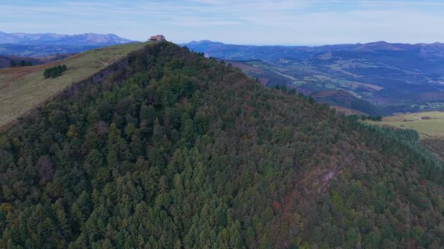 Aerial view from a drone of Mount Coliza (897 m) (Kolitza in Basque) with the chapel of San Sebasti&aacute;n and San Roque in the Ordunte Mountains in Valmaseda. Bizkaia, Basque Country, Spain.