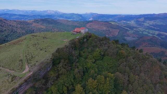 Aerial view from a drone of Mount Coliza (897 m) (Kolitza in Basque) with the chapel of San Sebasti&aacute;n and San Roque in the Ordunte Mountains in Valmaseda. Bizkaia, Basque Country, Spain.