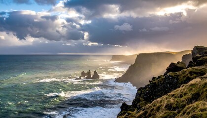 Dramatic coastline vista with cliffs, ocean waves, and sunlight piercing stormy skies