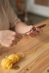Obraz premium The seamstress threads the thread into a large sewing needle