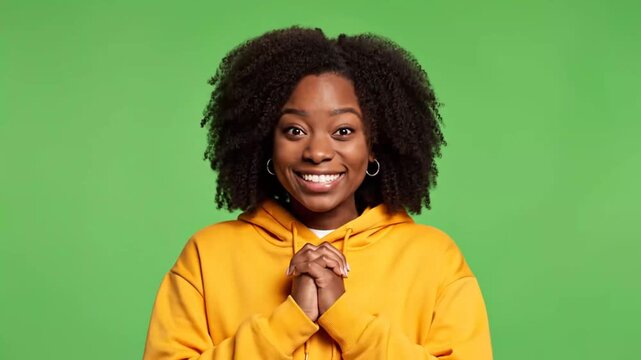 Woman with surprised expression on green backdrop studio portrait