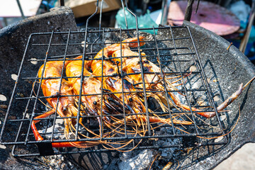 Big river prawn shrimp grilled on fire with smoke