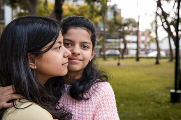 Fototapeta premium Portrait of Two Happy Sisters Smiling Together in Park