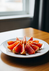 Vertical natural angle shot of grapefruit segments prepared for breakfast on breakfast table close up view &mdash; Natural Angle
