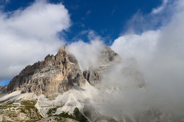 Tre Cime di Lavaredo massif wrapped in mist from Auronzo Refuge trail