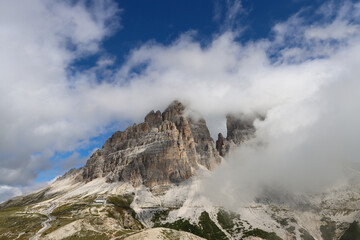 Tre Cime di Lavaredo hidden in clouds from Rifugio Auronzo trail