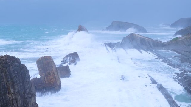 Storm and high waves in the Cantabrian Sea in the Liencres Natural Park within the Costa Quebrada Geopark. Liencres, Cantabria, Spain, Europe