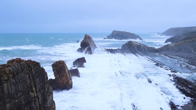 Storm and high waves in the Cantabrian Sea in the Liencres Natural Park within the Costa Quebrada Geopark. Liencres, Cantabria, Spain, Europe