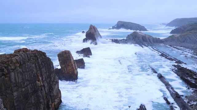 Storm and high waves in the Cantabrian Sea in the Liencres Natural Park within the Costa Quebrada Geopark. Liencres, Cantabria, Spain, Europe