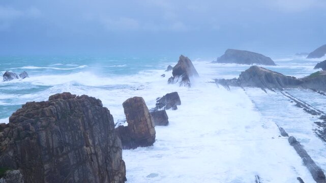 Storm and high waves in the Cantabrian Sea in the Liencres Natural Park within the Costa Quebrada Geopark. Liencres, Cantabria, Spain, Europe