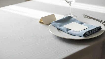 A beautifully set table with a blue napkin and white plate