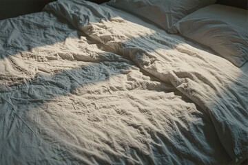 Soft Morning Light on Crumpled Bed Linen in Cozy Bedroom Setting