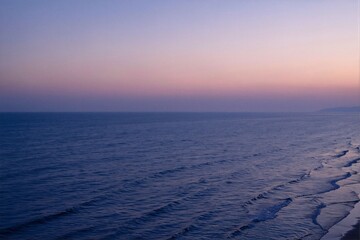 Serene Sunset Over Calm Ocean Waves and Tranquil Horizon