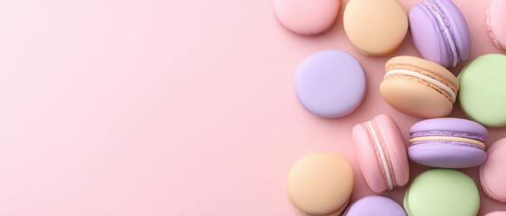 Obraz premium Pastel colored macarons arranged on soft pink background, delicate bakery items with minimal style and gentle tones creating sweet and inviting atmosphere