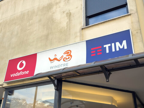 Ponte Nelle Alpi, Italy - January 27, 2026: Vodafone, WindTre, and TIM signage displayed on a storefront in an urban setting, showcasing telecommunications brands in Italy