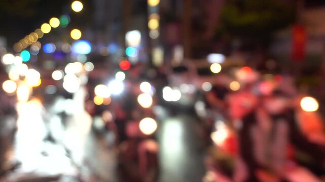 Asia, Vietnam , Ho Chi Minh,  blurred lights of city traffic . Congested traffic of cars and scooters on the streets of Saigon night  - Air pollution PM10 and fine particles above the permitted thresh
