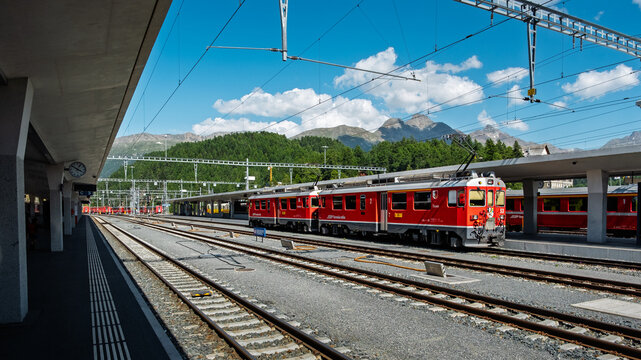 Red RhB train at St. Moritz railway station in the Swiss Alps, Europe