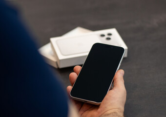 Germany - September 20, 2025. Man holding the newly released silver Apple iPhone 17pro max 