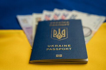 Fototapeta premium Ukrainian Passport with Hryvnia Cash on Blue Yellow Background