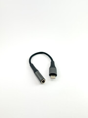 Fototapeta premium Dark Smartphone to AUX Audio Adapter Cable on White Background