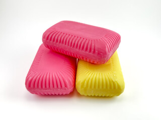Three Colorful Soap Bars on White Background &ndash; Two Red, One Yellow