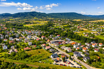 Aerial panoramic view of disperse housing of residential district of Andrychow city with Beskidy Mountains in background in Lesser Poland © Art Media Factory