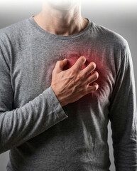 Man clutching chest with red highlighted pain area indicating heart attack, heartburn, or inflammation.