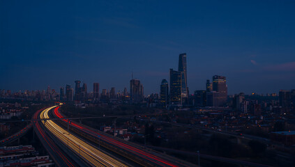 Modern City Skyline at Night with Light Trails