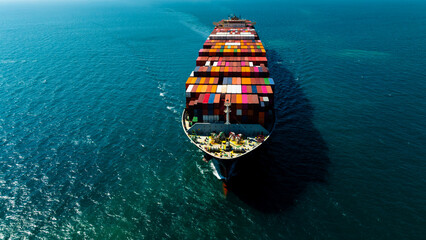 Aerial front view of cargo container ship sailing forward in deep sea for global business logistics and international commercial maritime import export transportation. © SHUTTER DIN