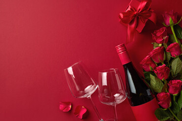 Valentine's day composition of red wine bottle, two glasses, gift box and red roses