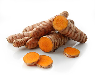 Whole and sliced fresh turmeric root on white background