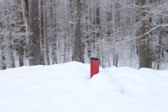 Red coffee mug at the show. thermos bottle or flusk