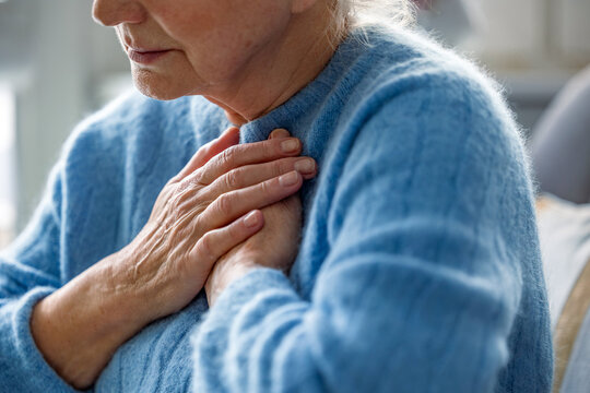 Senior woman suffering from chest pain
