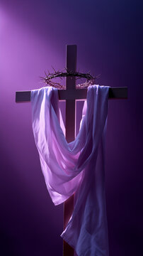Wooden cross with crown of thorns and purple cloth symbolizing holy week passion and easter resurrection. 