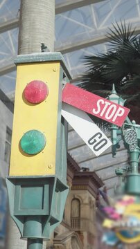 Close up shows retro traffic signal with mechanical sign, where GO permission changes to STOP to halt traffic. vertical