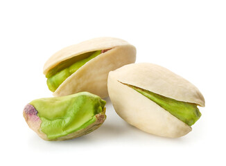 Close-up of three pistachios on white background