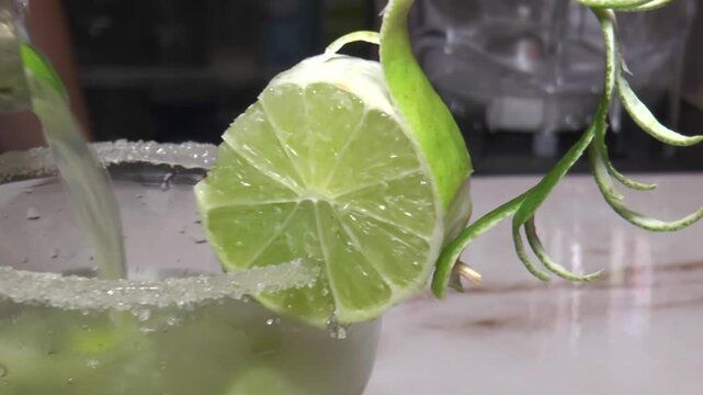 Close up of bartender preparing caipirinha cocktail with sugar rim