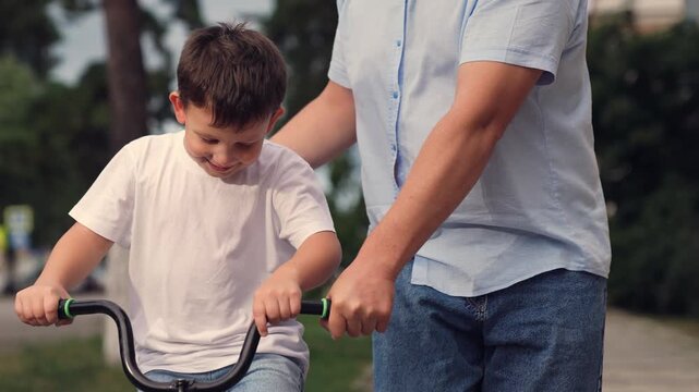 father teaches child ride bike, boy laughs smiling sitting bike outdoors, horse riding, boy laugh smile face, child riding bike, boy brown hair, child boy toothless smile, kid dental surgery, loss