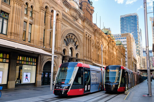 Light rai trains stopping at stop of Queen Victoria Building (QVB). It is a historical building and now is converted into luxury shopping mall in SYDNEY, NEW SOUTH WALES, AUSTRALIA on SEP 13, 2024