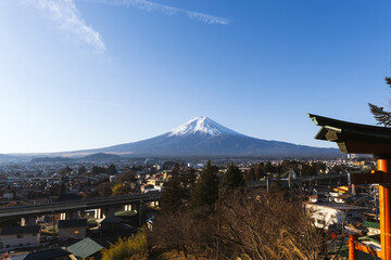 Panoramic view of Mount Fuji over Fujiyoshida city with traditional architecture.