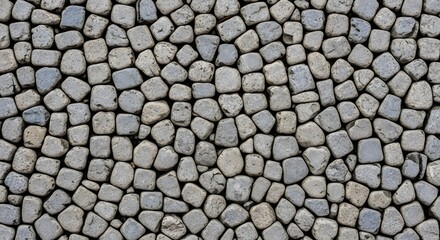 Close up of a mosaic stone floor or wall with small gray pebbles