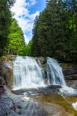 Fototapeta premium Mumlava waterfall in Harrachov flowing through forest