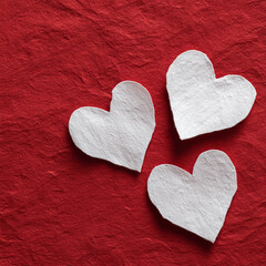 White Paper Hearts on Red Textured Background