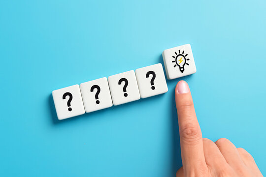Hand Selecting Lightbulb Block After Four Question Marks &mdash; Problem Solving, Critical Thinking, Decision Making, and Insight Discovery Concept Hand pointing to lightbulb block after four ?