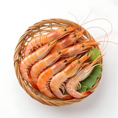 Freshly caught orange prawns in a wicker basket with green leaves white background