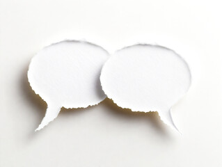 Two white paper cutouts of speech bubbles with one of them cut off. Concept of communication and the importance of expressing oneself