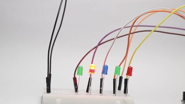 Breadboard circuit consisting of different color LED lights that blink one after the other in a sequence showing the concept of data order